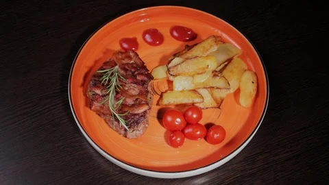 Meat with fried potatoes on a plate Stock Footage 329077383