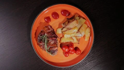 Meat with fried potatoes on a plate Stock Footage 329077387