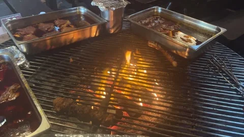 Meat is fried in a restaurant over an open fire. Video stock 287550088