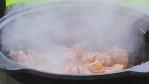 Meat frying in kazan Stock Footage 310181145