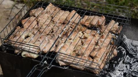 Meat grilled on the grid. Roast meat with different sides on the barbecue. Stock Footage 64573754