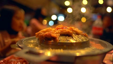 Meat grilled on hot pan and soup for eating of party in restaurant at night Stock Footage 147150076