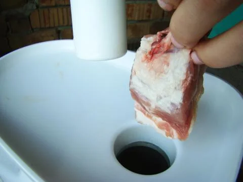 Meat grind in a meat grinder Stock Photos