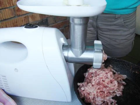 Meat grind in a meat grinder Stock Photos