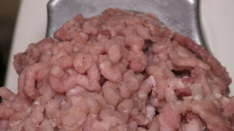 Meat grinder grinds raw meat Видео 143579226