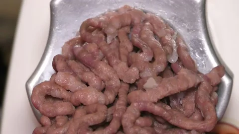 Meat grinder grinds raw meat Stock Footage 143579336