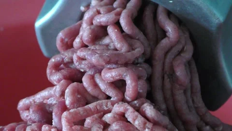 A meat grinder grinds raw meat into minced meat Video stock 165151623