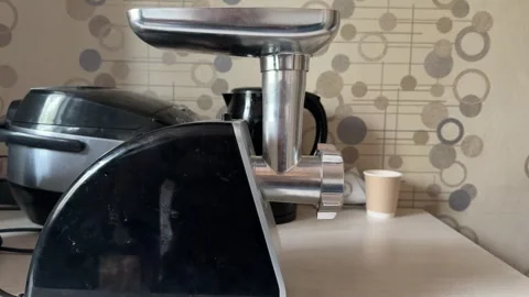Meat grinder machine in home kitchen close up, food processing appliance and Stock Footage 337120020