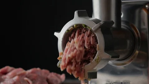 Meat grinder makes minced meat, man throws meat into a meat grinder Stock Footage 126822004
