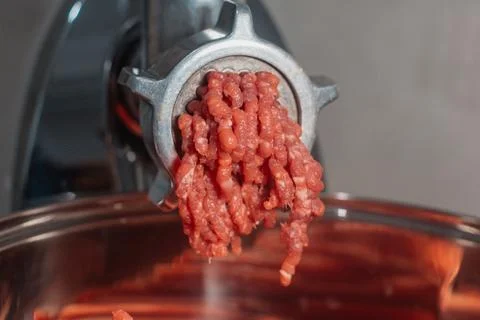 The meat grinder makes minced meat. selective focus Stock Photos