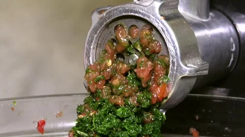 A meat grinder squeezes out healthy green herbs Stock Footage 341765492