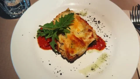 Meat lasagna with basil leaf on the top. Close-up of italian dish. Stock Footage 297770089