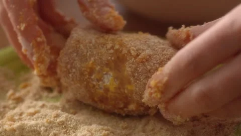 Meat loaf is dipped in breadcrumbs. Stock Footage 258651601