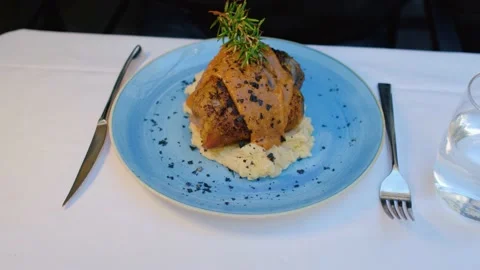 Meat with mashed potatoes in a plate. Close-up, selective focus. Video stock 238444020