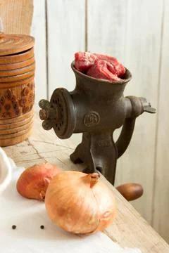 Meat in a meat grinder, rustic style, selective focus. Stock Photos