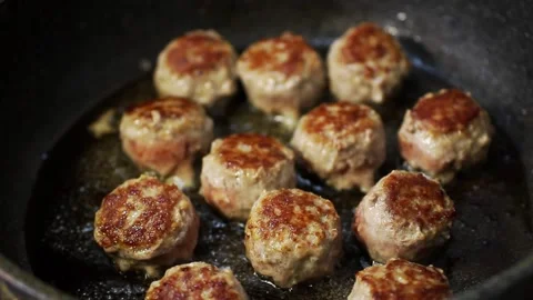 Meat meatballs are fried in olive oil in a frying pan Stock Footage 153773903