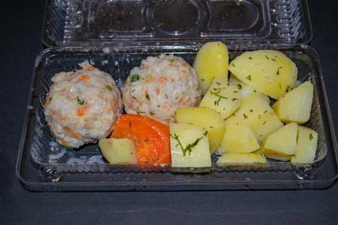 Meat meatballs with boiled potatoes and boiled carrots in a plastic container Stock Photos