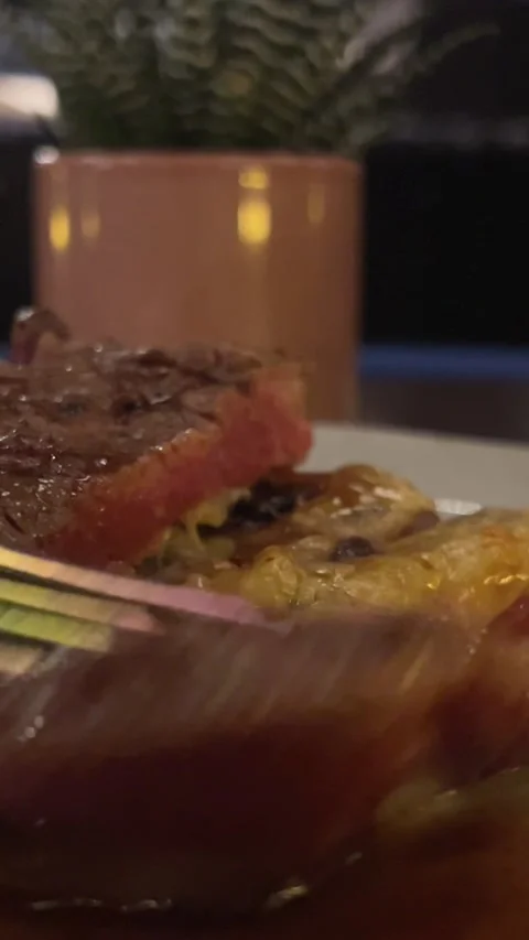 Meat medium rare in a dark restaurant Stock Footage 302069765