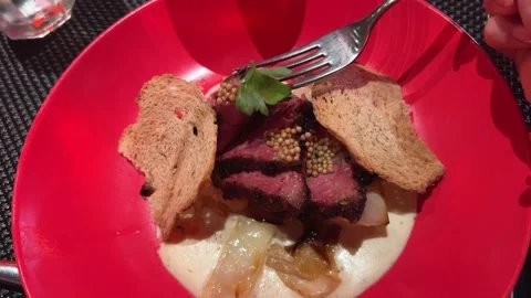 Meat medium ro on red plate croutons woman takes a piece of tasty barbecue with Stock Footage 293132614