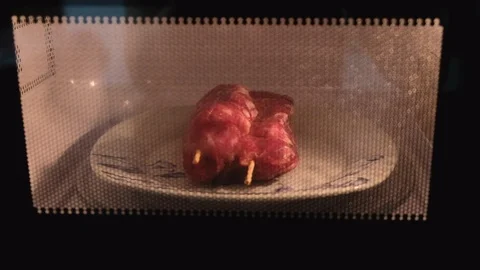 Meat in the microwave oven Stock Footage 107972385