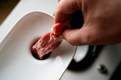 Meat Mincing process with electric meat grinder Stock Photos