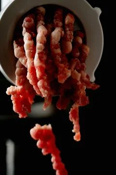 Meat Mincing process with electric meat grinder Stock Photos