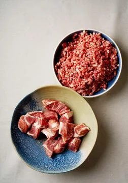 Meat Mincing process with electric meat grinder Stock Photos