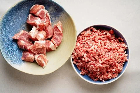 Meat Mincing process with electric meat grinder Stock Photos