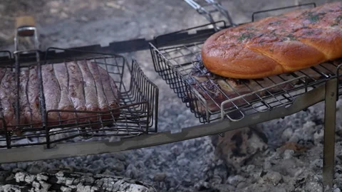 Meat on an open fire and bread on a grid. Stock Footage 252493558