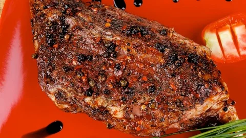 Meat over white : grlled meat shoulder on red plate Video stock 88921892