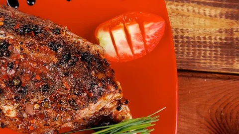 Meat over white : grlled meat shoulder on red plate Video stock 88921953