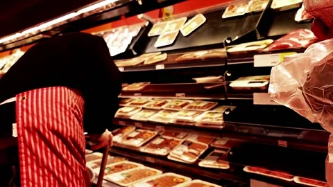 Meat packaged at the grocery store closeup employee with gloves hands Stock Footage