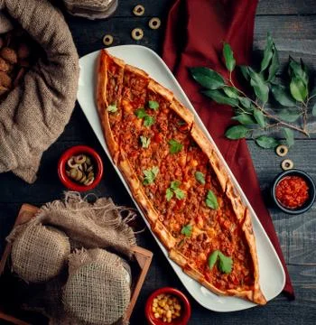 Meat pide with green on the table Stock Photos