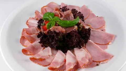 Meat plate, Sliced ham and jamon on top, served in Restaurant Stock Footage 84262353