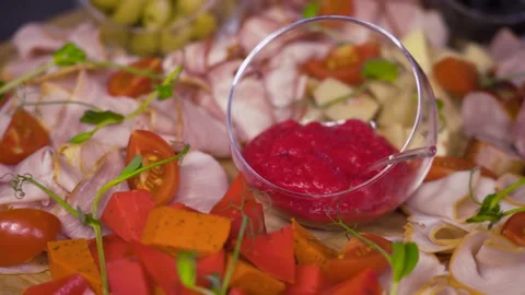 Meat Platter Appetizer with Cheese, Olives and Cherry Tomatoes at Buffet Stock Footage 314853920