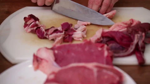 Meat preparation - chopping side steak onto cubes with sharp knife Stock Footage 44726838