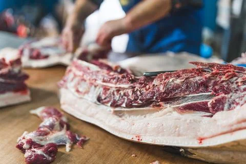 Meat preparing process at the butchers shop, working on the meat Stock Photos