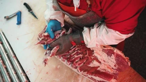 Meat processing factory. Plant workers is cutting off carcasses 스톡 동영상 244322474