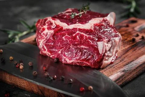 Meat processing plant. carcasses of beef hang on hooks. Stock Photos