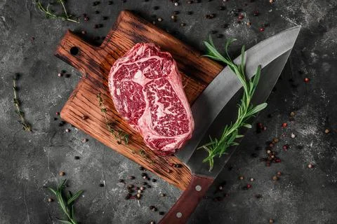 Meat processing plant. carcasses of beef hang on hooks. Stock Photos
