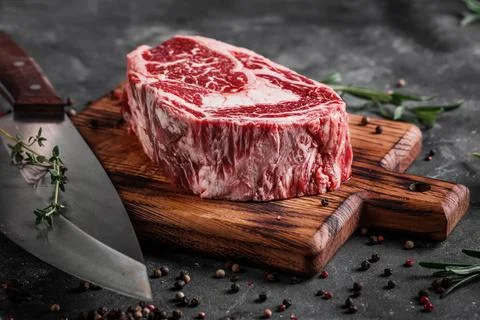 Meat processing plant. carcasses of beef hang on hooks. Stock Photos