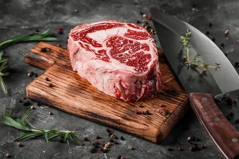 Meat processing plant. carcasses of beef hang on hooks. Stock Photos