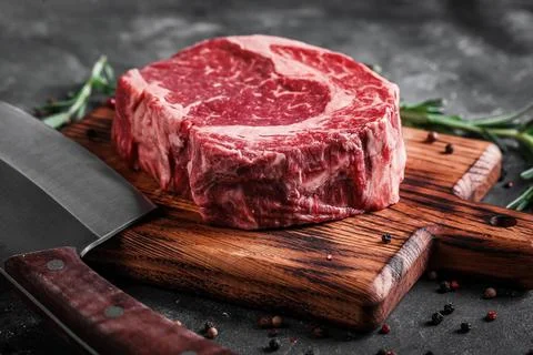 Meat processing plant. carcasses of beef hang on hooks. Stock Photos