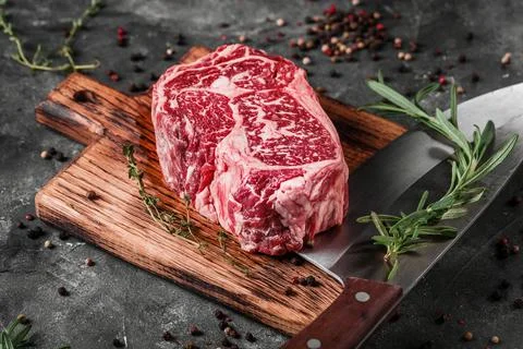 Meat processing plant. carcasses of beef hang on hooks. Stock Photos