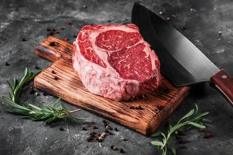 Meat processing plant. carcasses of beef hang on hooks. Stock Photos