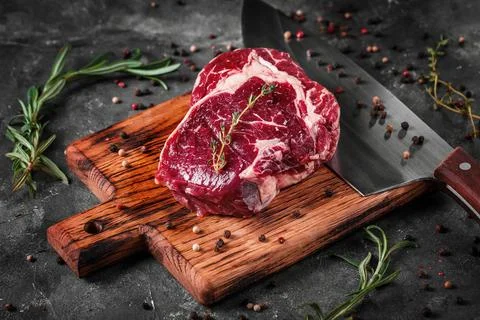 Meat processing plant. carcasses of beef hang on hooks. Stock Photos