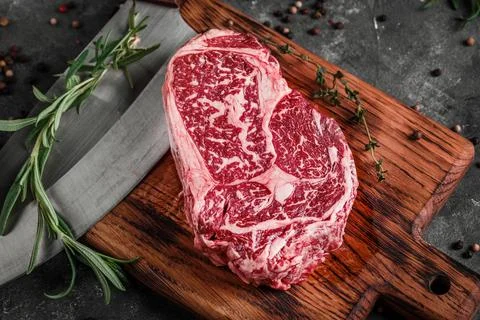 Meat processing plant. carcasses of beef hang on hooks. Stock Photos