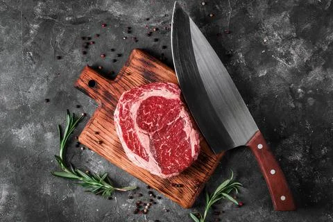 Meat processing plant. carcasses of beef hang on hooks. Stock Photos