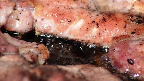 Meat put fried on a metal disk. Beside it sizzles hot oil Stock Footage 171062018
