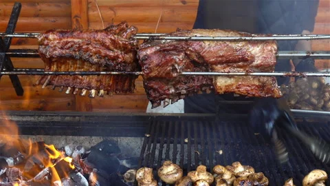 The meat ribs are fried rotating on a grill. Stock Footage 129837909